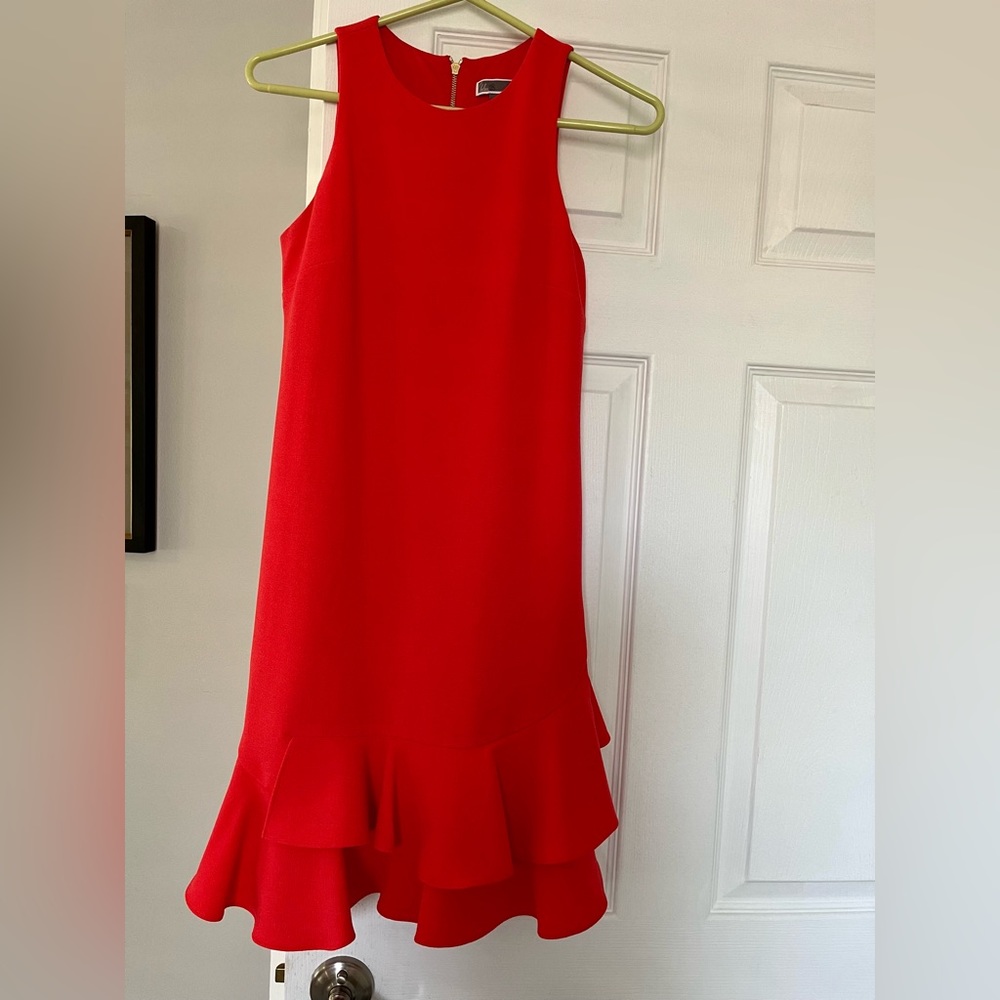 Bright coral color dress with fun ruffles at the bottom.